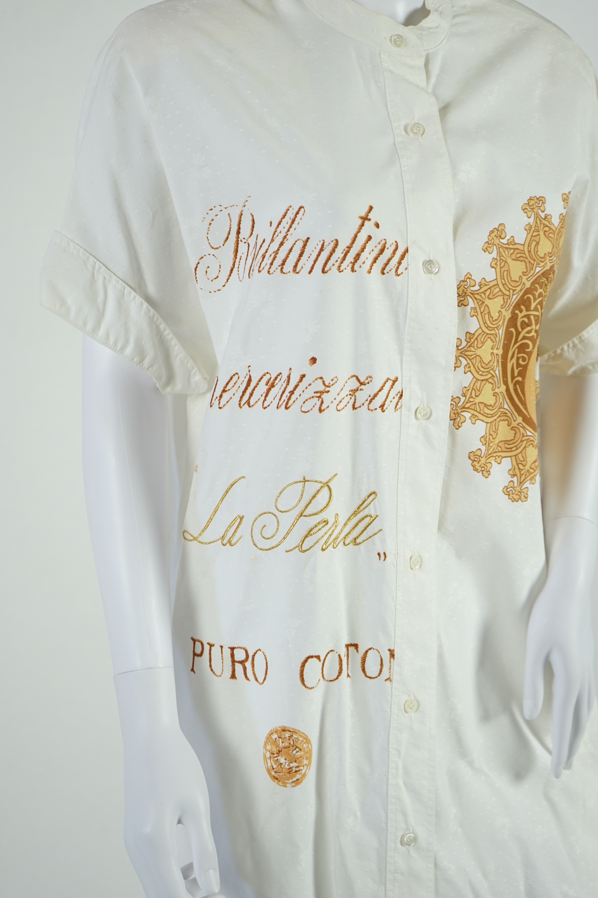 A La Perla white trouser lounge suit, a black jacket lounge jacket, a fawn silk dress and a white embroidered shirt dress. Approx Size L Proceeds to Happy Paws Puppy Rescue